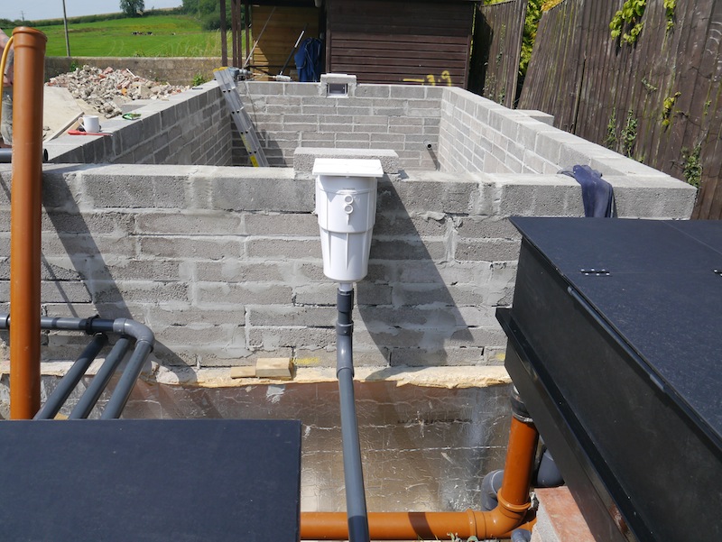 Skimmer mounted onto koi pond wall